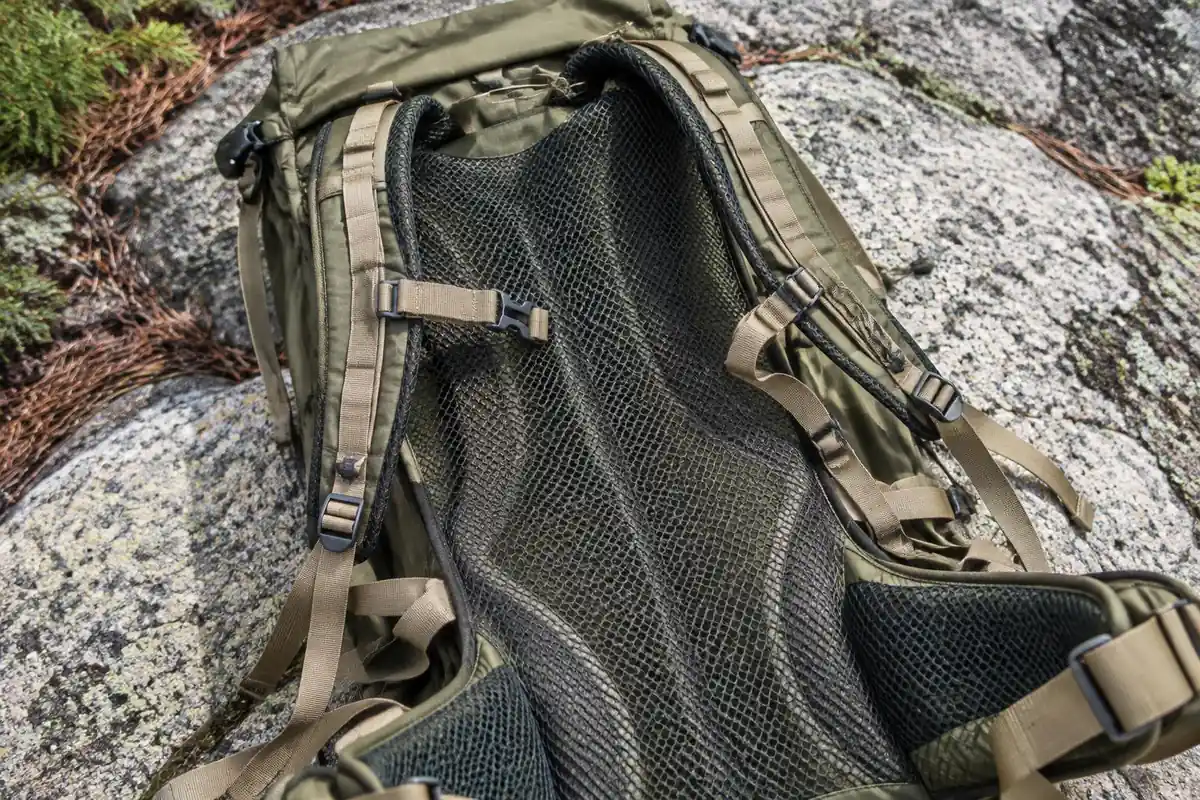 Ventilated mesh back panel of a pack resting on granite