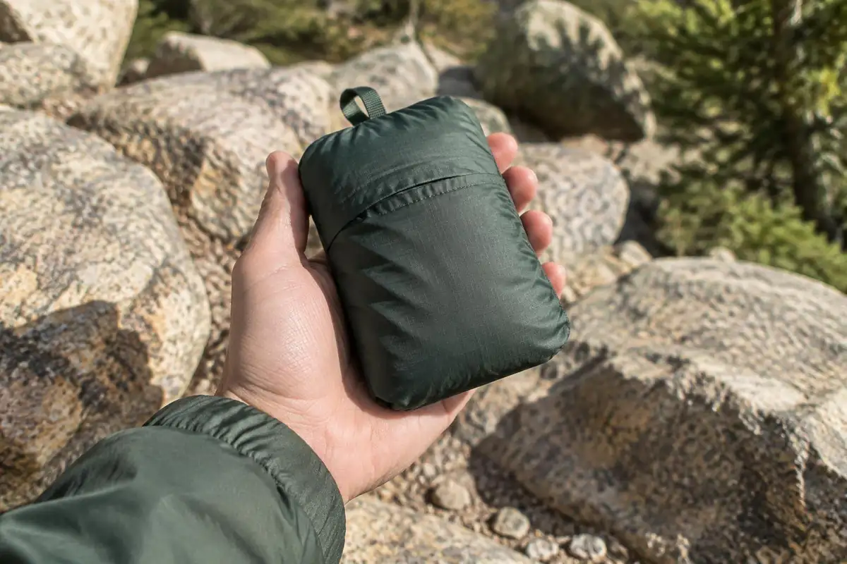 Small folded pack the size of a fist held in one palm