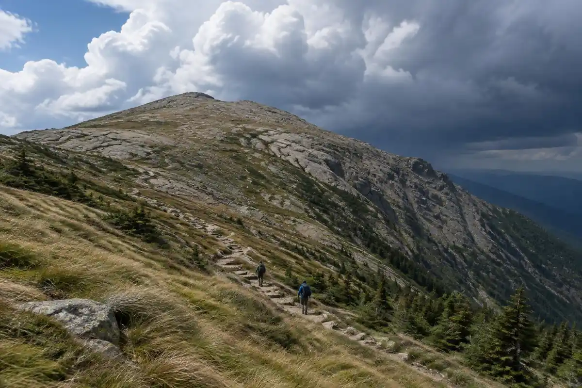 Dark clouds building over a bare granite ridge above the tree line at midday